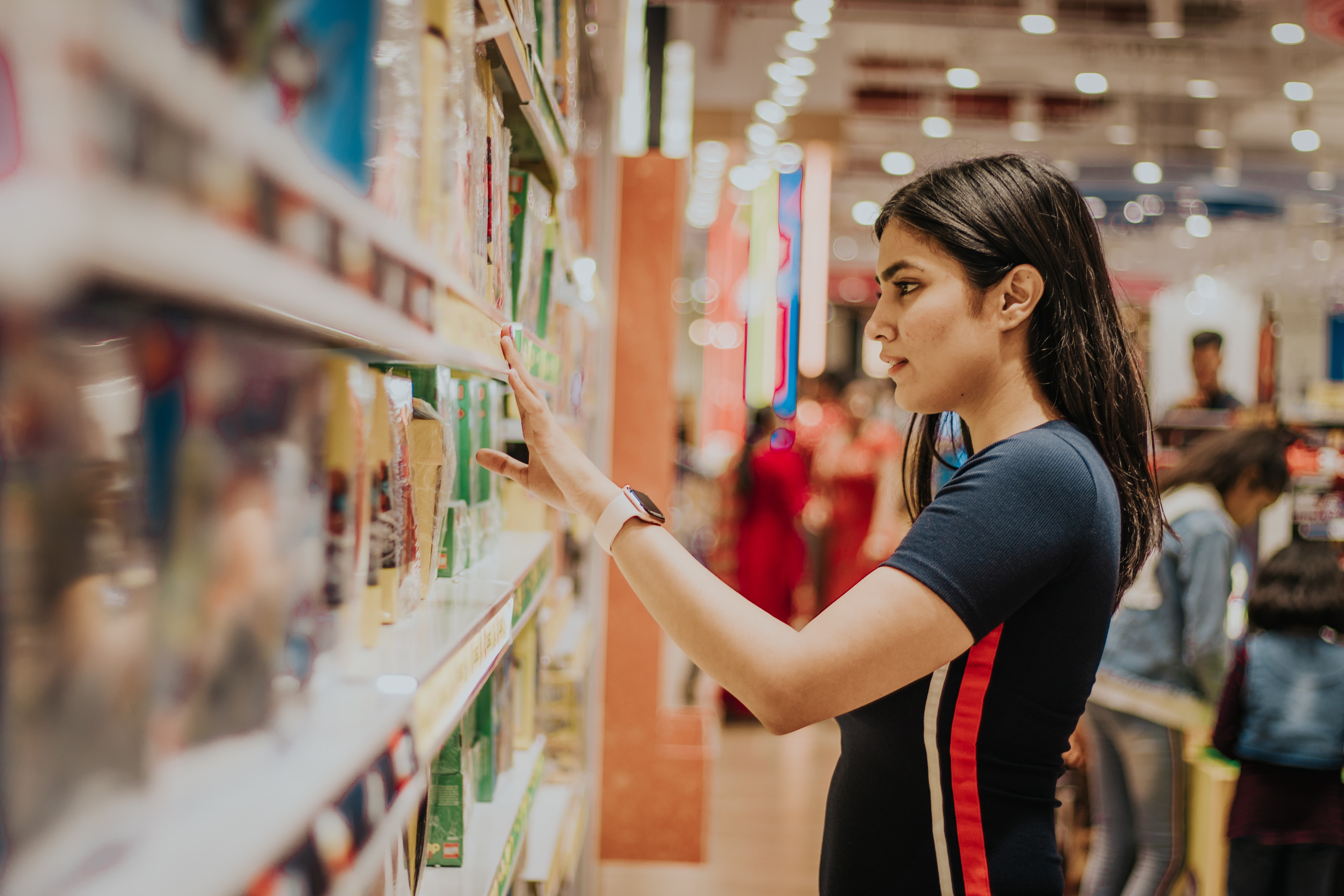 Shopper choosing product on store shelf